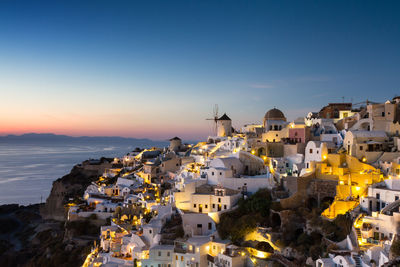 High angle view of townscape by sea against sky