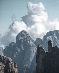 Low angle view of snowcapped mountains against sky