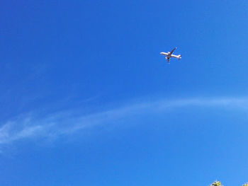 Low angle view of airplane flying in sky