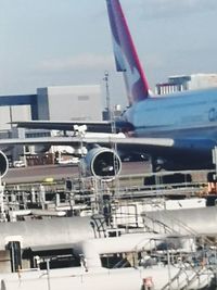 Airplane at airport against sky