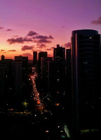 Illuminated cityscape against sky at night