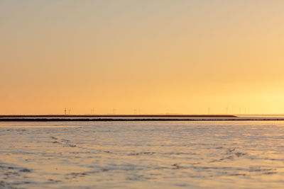 Scenic view of sea against clear sky during sunset