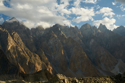 Scenic view of mountains against cloudy sky