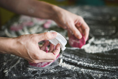 Close-up of woman hands making pasta