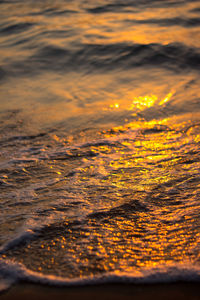 Close-up of sea against sky at sunset