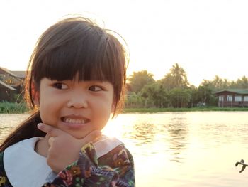 Portrait of cute boy in lake against sky