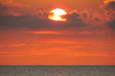 Scenic view of sea against orange sky