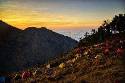 High angle view of tents on mountain against sky during sunset