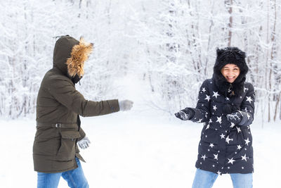 Woman with arms raised during winter