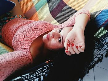 Portrait of woman lying on hammock