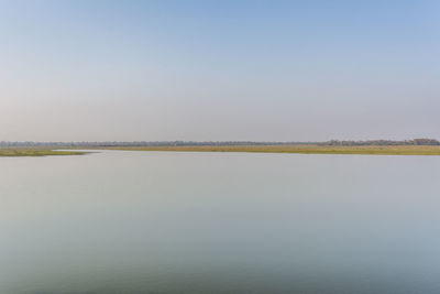 Scenic view of farm against clear sky