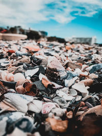 Close-up of pebbles on beach against sky