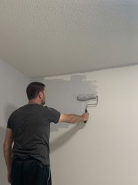 Man standing against wall
