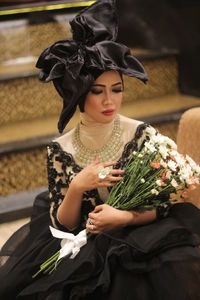 Midsection of woman holding bouquet