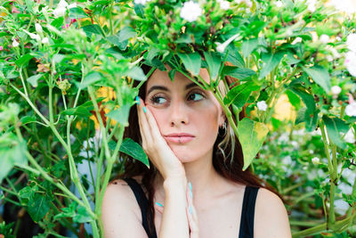 Thoughtful woman sitting alone outdoors. young worried in backyard