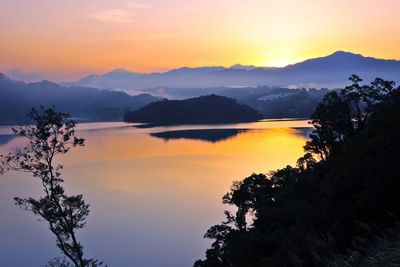 Scenic view of silhouette mountains against sky during sunset