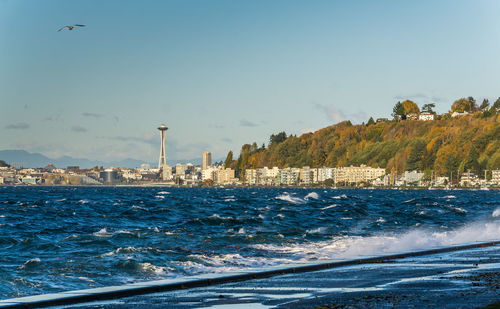 A view of elliott bay with alki beach condos in the distance.