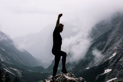 Man standing on mountain against sky