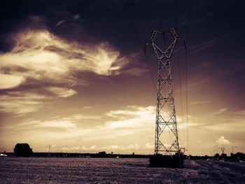 Low angle view of electricity pylon against sky