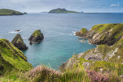 Small islands at dunquin pier surrounded by turquoise water, dingle, wild atlantic way, ireland