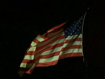 Low angle view of flag against sky at night