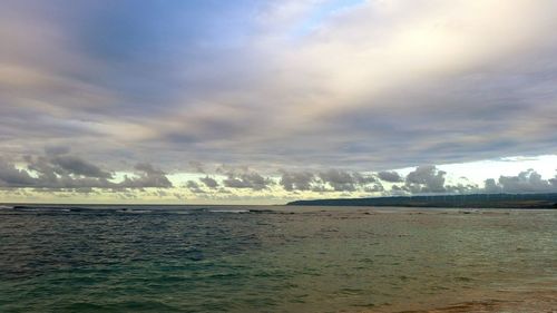 Scenic view of sea against cloudy sky