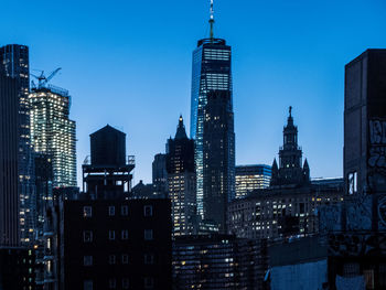 Low angle view of skyscrapers lit up at night