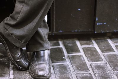 Low section of man standing on footpath