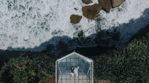 High angle view of man standing by sea