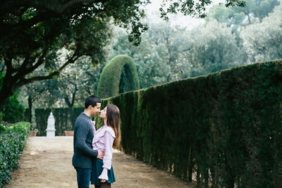 Full length of couple kissing in garden