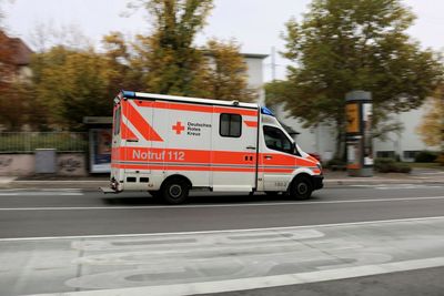Red car on road in city