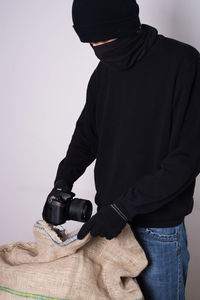 Close-up of man holding camera