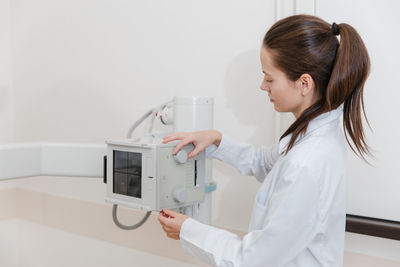 Doctor using medical equipment at hospital