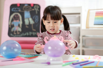 Young girl making craft for homeschooling 