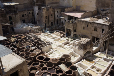 High angle view of tannery amidst houses in city on sunny day