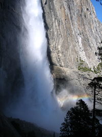 Low angle view of waterfall against sky