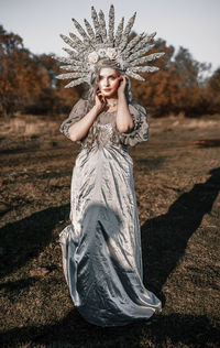 Portrait of young woman wearing costume standing outdoors