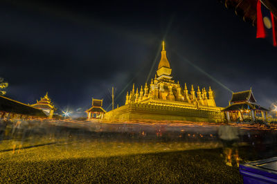 Illuminated temple building against sky at night