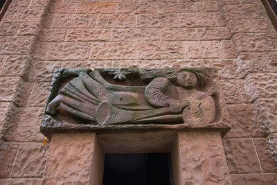 Low angle view of statue against building