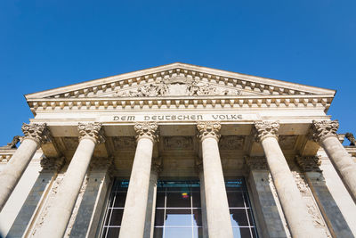 Low angle view of historical building against blue sky