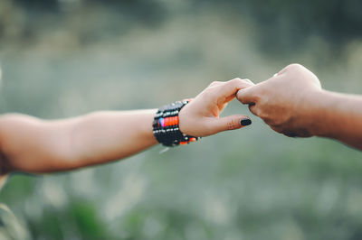 Cropped image of couple holding hands