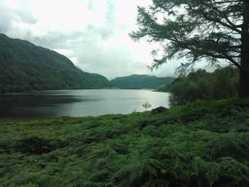 Scenic view of lake against cloudy sky