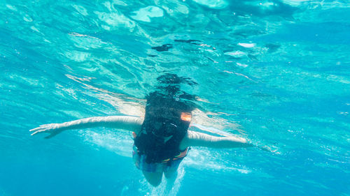 Low angle view of woman swimming in sea