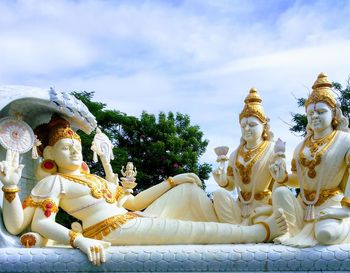 Statue against temple building against sky