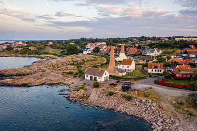 High angle view of river amidst buildings in town against sky