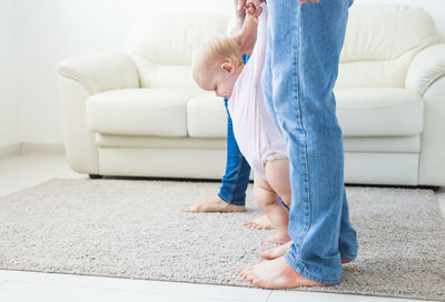 Parents playing with daughter at home