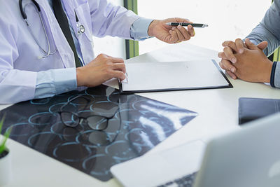 Midsection of man working on table