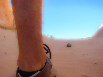 Man on beach against clear sky