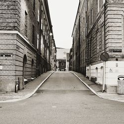 Street amidst buildings against clear sky