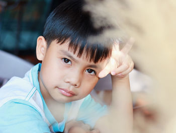 Face portrait cute asian boy 8-10 years old looking happy expression wearing white shirt